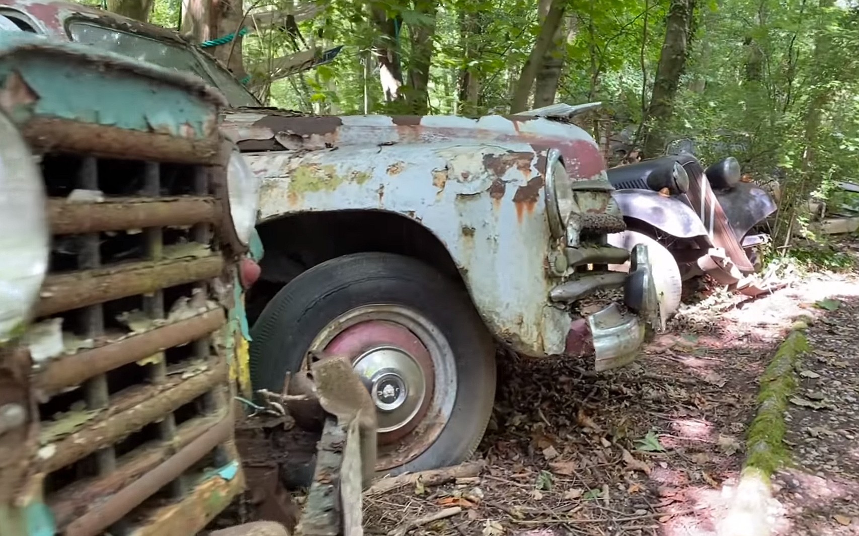 this junkyard set up in the woods is loaded with rare classic cars 7