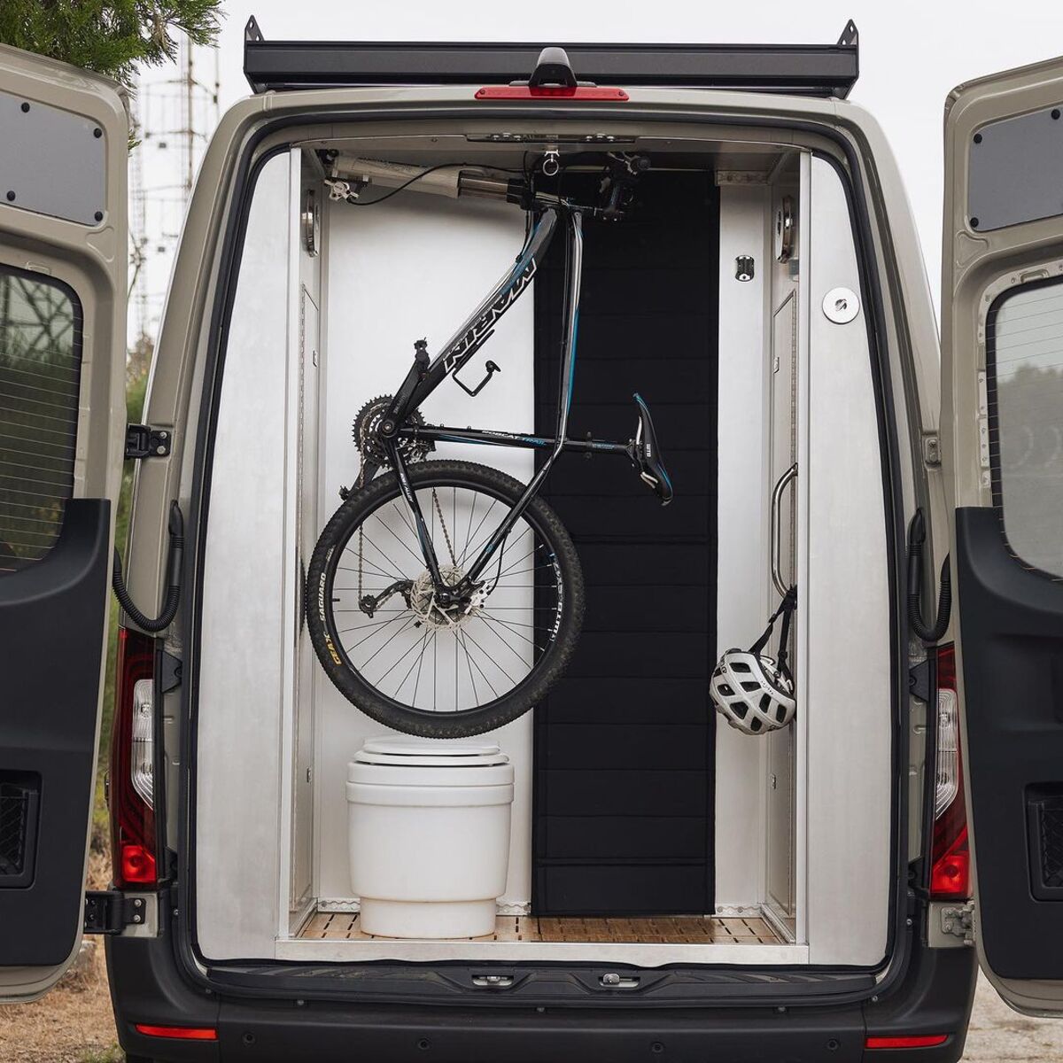 the nook van conversion offers spa bathroom and garage hidden kitchen and comfy lounge 11