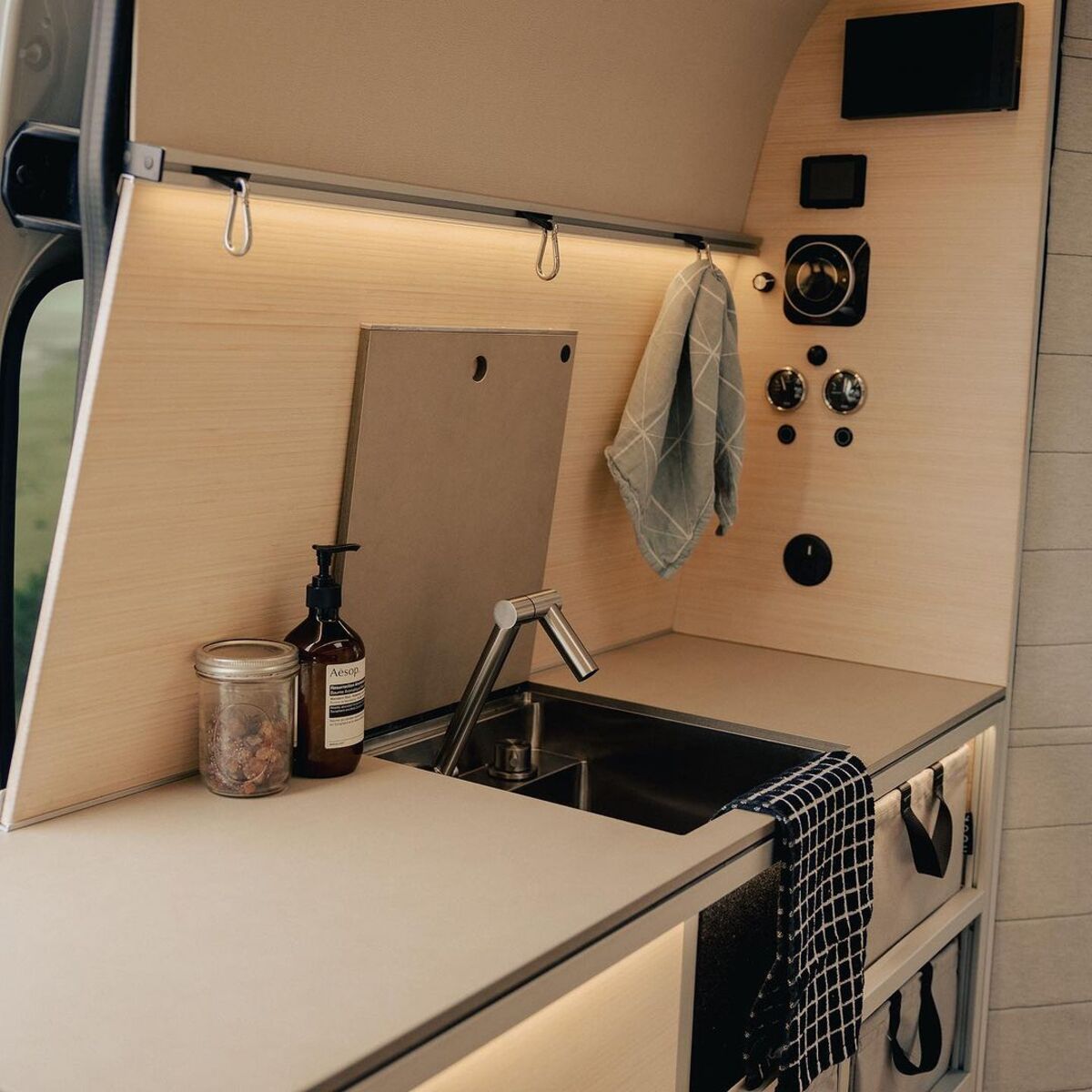 the nook van conversion offers spa bathroom and garage hidden kitchen and comfy lounge 12