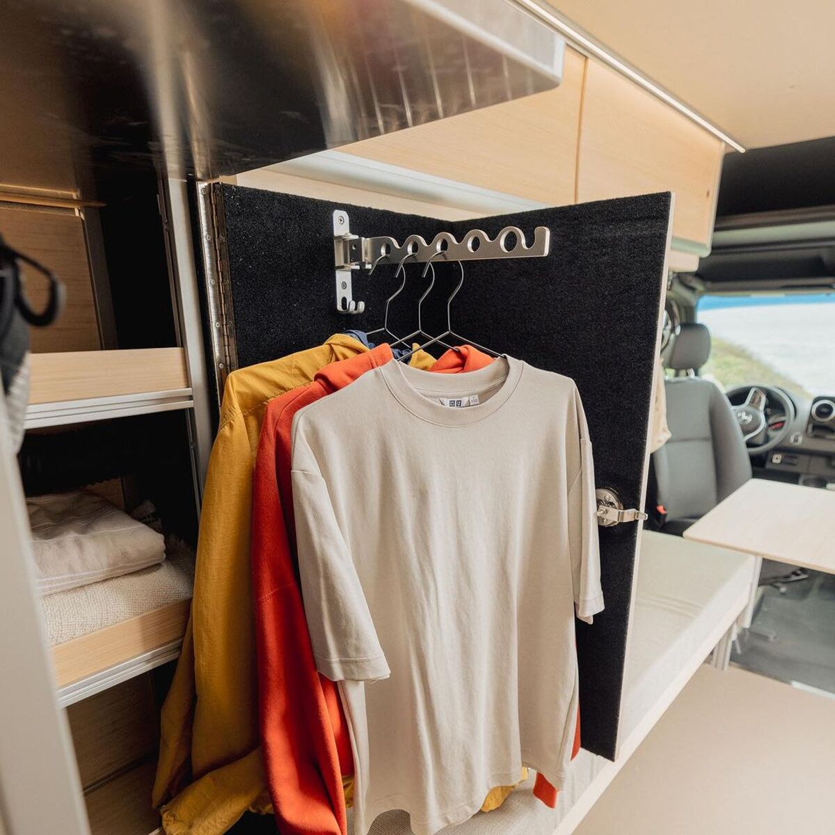 the nook van conversion offers spa bathroom and garage hidden kitchen and comfy lounge 13