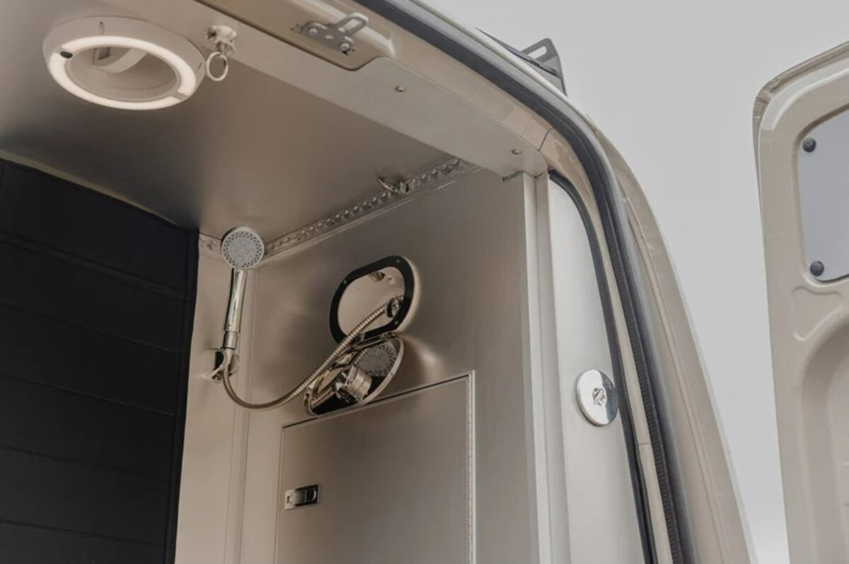 the nook van conversion offers spa bathroom and garage hidden kitchen and comfy lounge 27