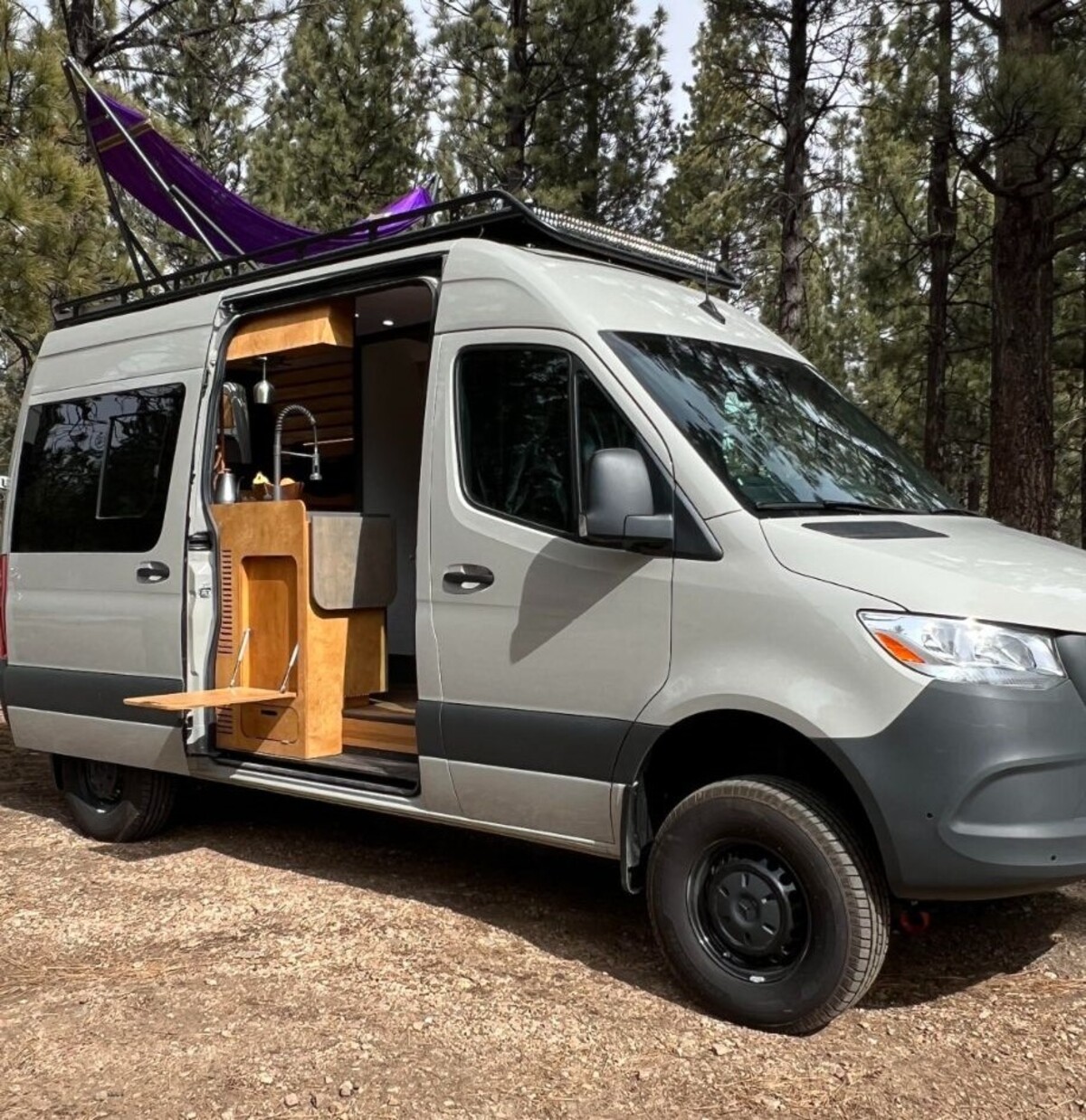 this luxurious big bear vans camper conversion has an elevator bed and rooftop decking 3